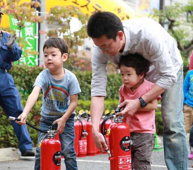 消火訓練中のパパと子ども